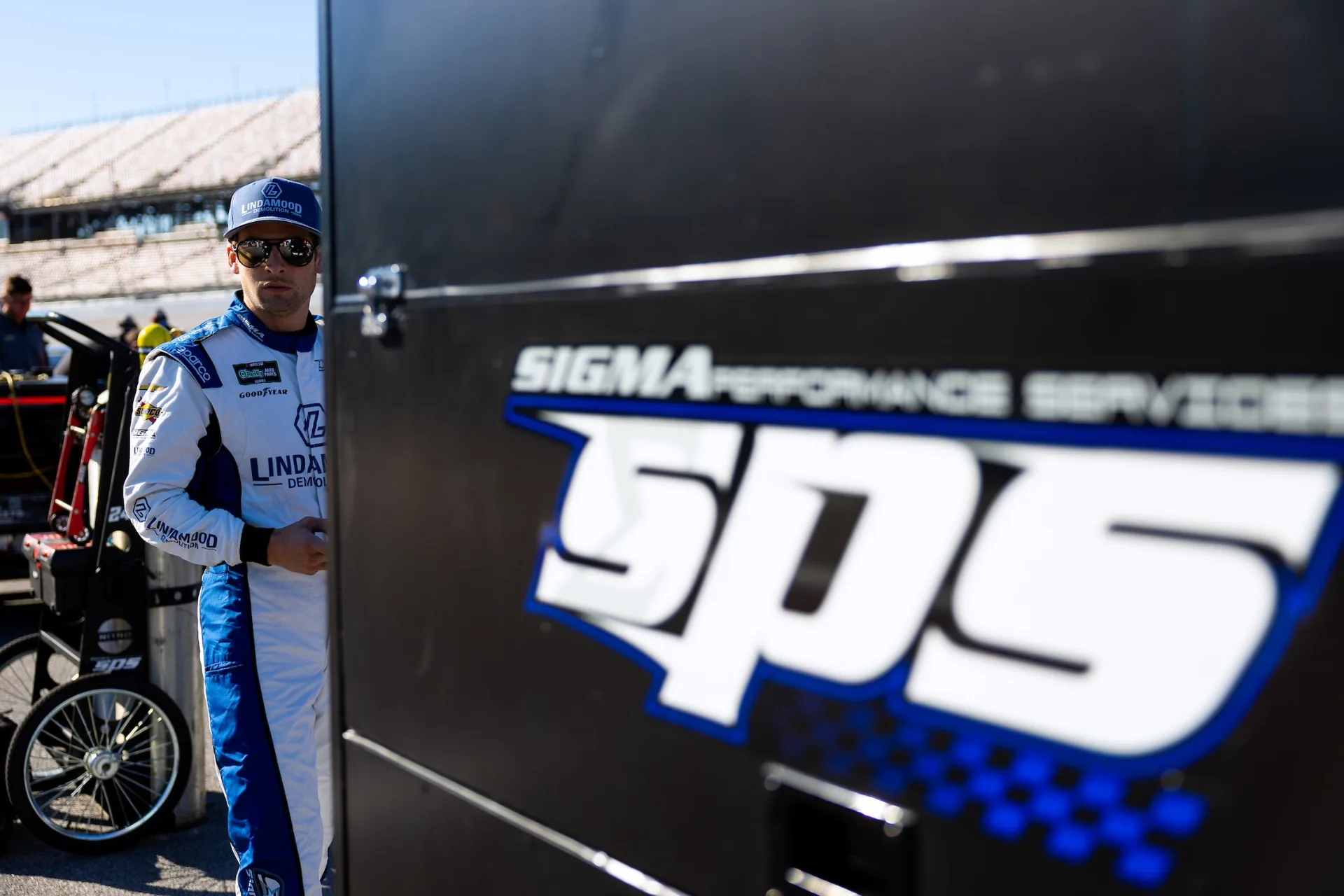 Connor Mosack beside SPS Racing equipment at Talladega Superspeedway.