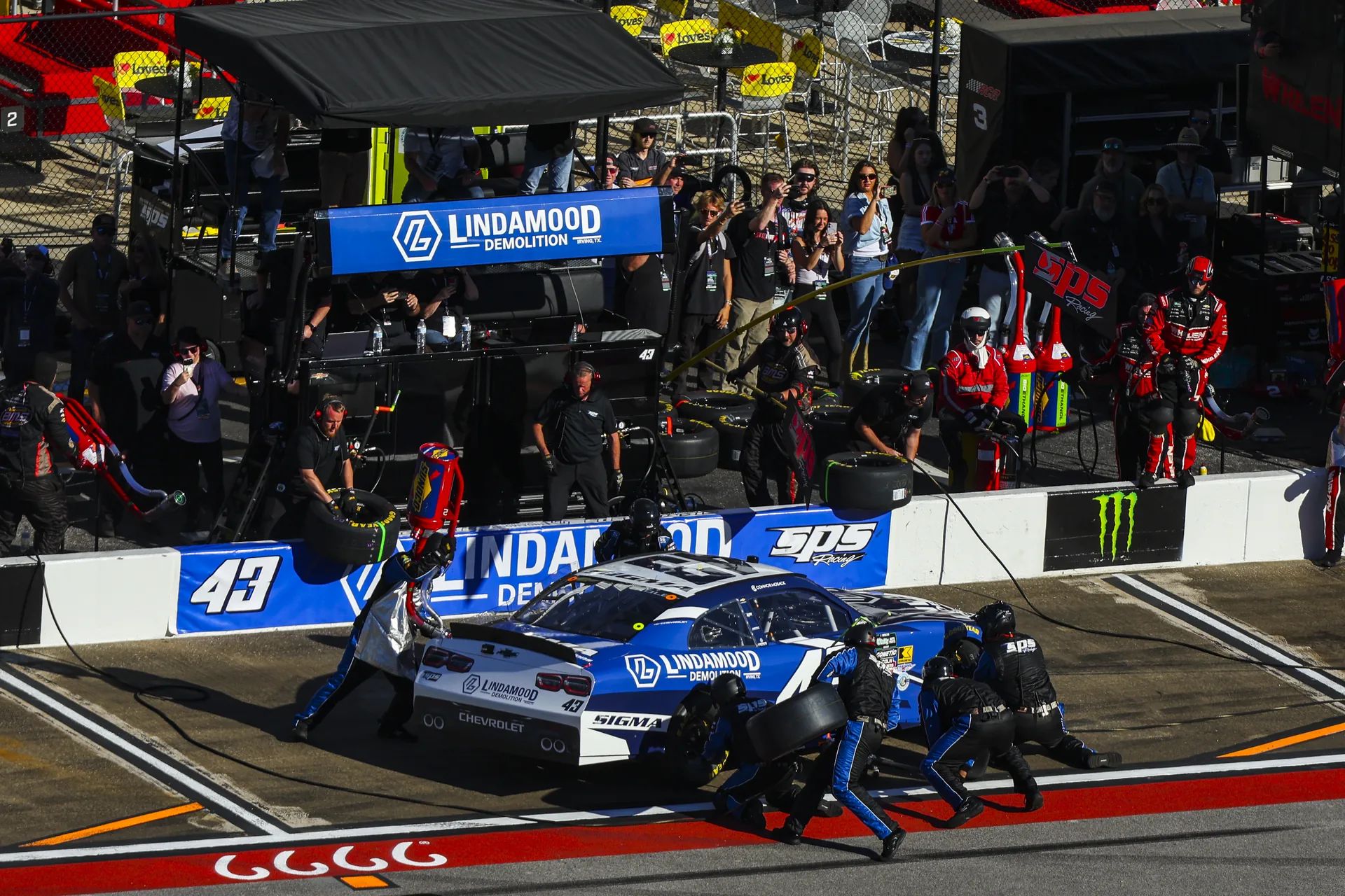 Crew members service the No. 43 Lindamood Chevrolet during a pit stop at Talladega Superspeedway.